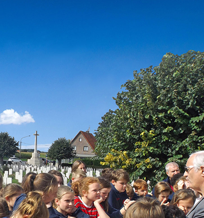 School childeren with teachers and guide visiting war graves