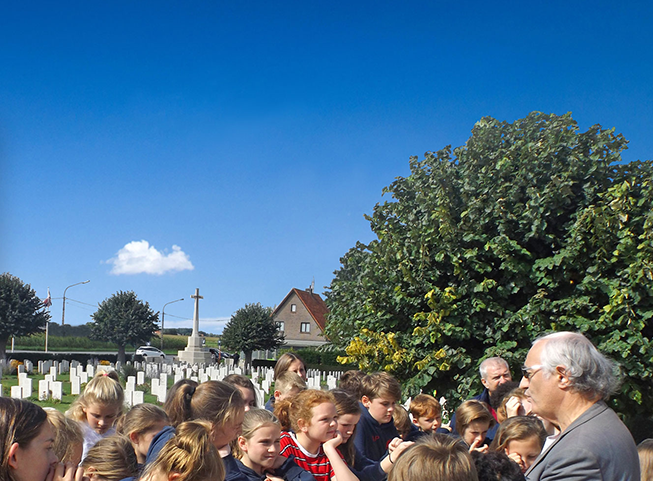 School childeren with teachers and guide visiting war graves